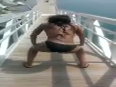 In a bikini, a dissolute black woman with a hawt physique shakes her enormous wazoo.